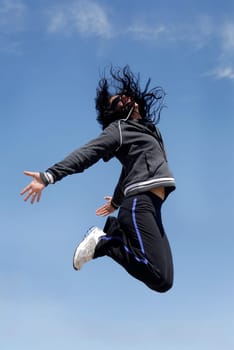 Woman jumping high outdoors