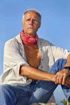 Handsome mature man adventurer posing outdoors