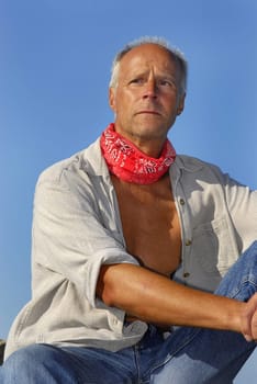 Handsome mature man adventurer posing outdoors