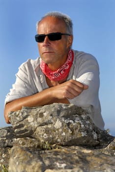 Handsome mature man adventurer posing outdoors