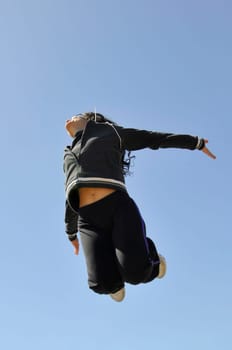 Woman jumping high outdoors