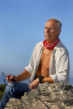 Handsome mature man adventurer posing outdoors