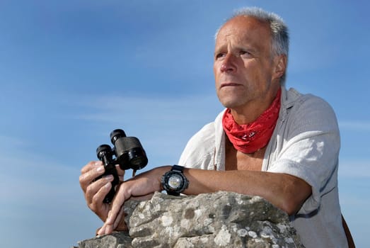 Explorer with is binoculars looking for adventure, outdoors