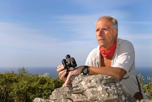 Explorer with is binoculars looking for adventure