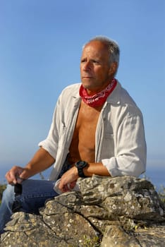 Handsome mature man adventurer posing outdoors