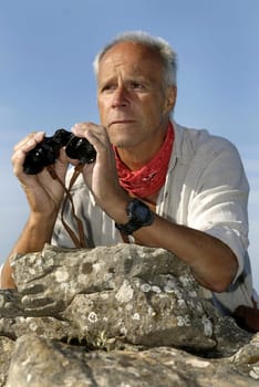 Explorer with is binocular looking for adventure