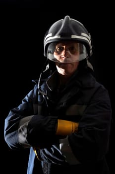 Fireman in uniform isolated in black