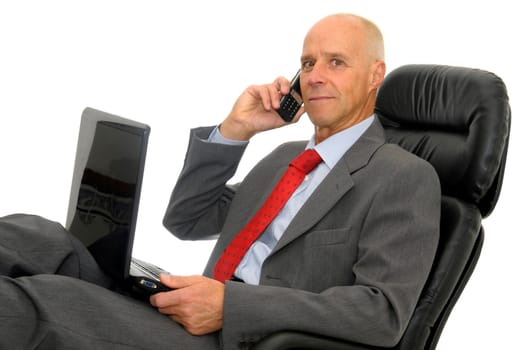 Mature man with cellphone and laptop isolated in white