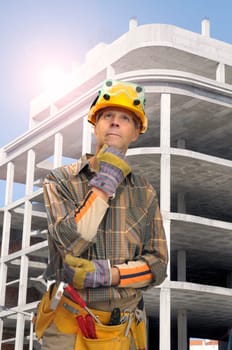 Worker with constrution site in the background
