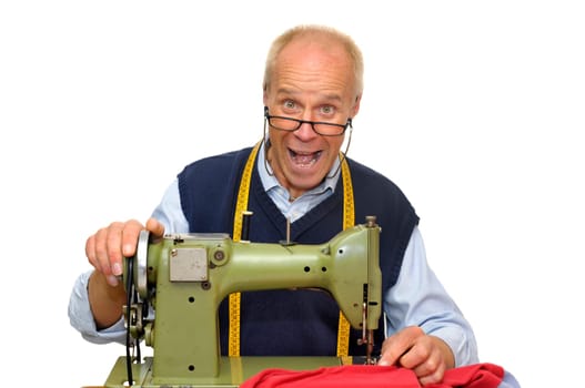 Mature tailor with a sewing machine isolated in white