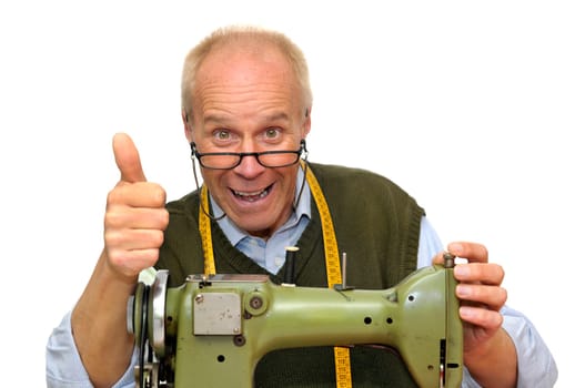 Mature tailor with a sewing machine isolated in white