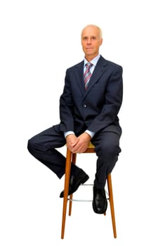 Mature businessman in a chair isolated in white