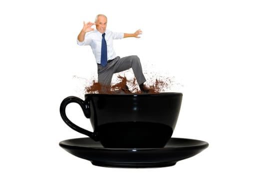 Mature businessman jumping from a coffee mug isolated in white
