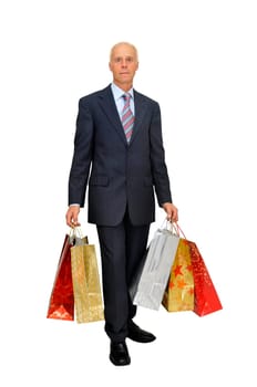 Mature businessman with lots of bags shopping isolated in white