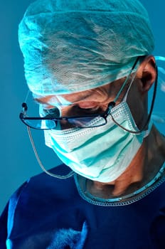 Doctor portrait in surgery in blue tones