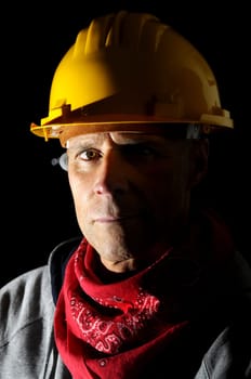 Portrait of a miner isolated in black
