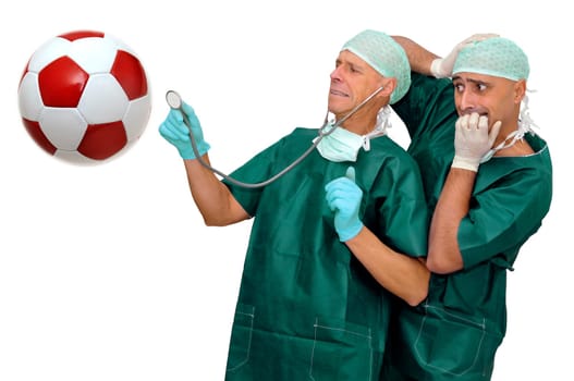 Doctors with scared faces inspecting a soccer ball isolated in white