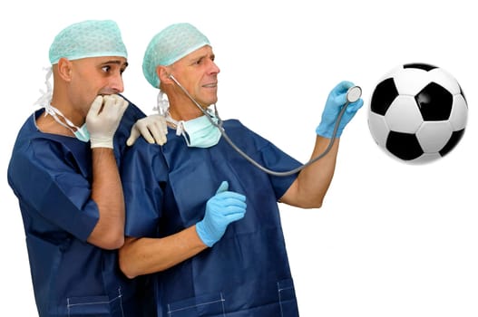 Doctors with scared faces inspecting a soccer ball isolated in white