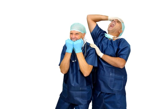Doctors team in uniform making funny faces isolated in white