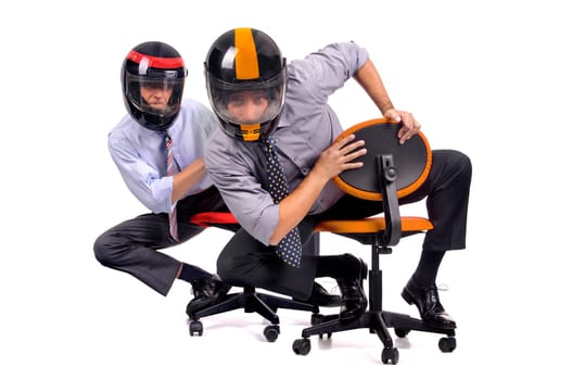 Businessmen racing in chairs with helmets
