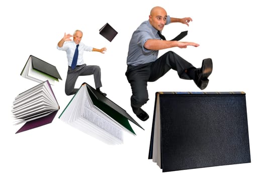 Businessmen jumping over books isolated in white