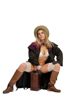 Sexy girl in cowboy outfit isolated in white