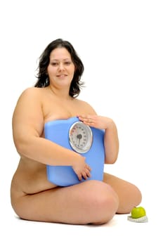 Beautiful nude large girl with weight scale isolated in white