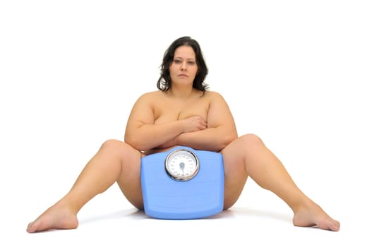 Beautiful nude large girl with weight scale isolated in white
