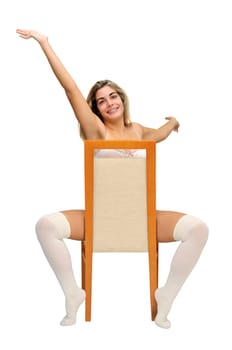 Sexy girl in white lingerie seated in a chair isolated in white