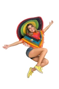 Happy girl jumping with a big sombrero isolated in white