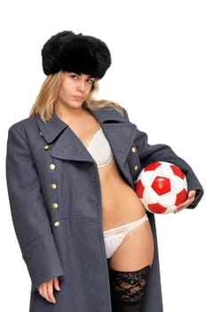 Sexy girl in russian army greatcoat and lingerie holding a soccer ball isolated in white