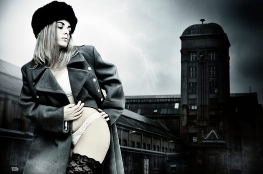 Sexy girl in russian army greatcoat and lingerie isolated in white