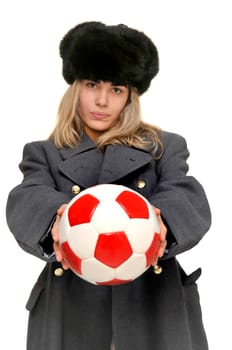 Sexy girl in russian army greatcoat and lingerie holding a soccer ball isolated in white