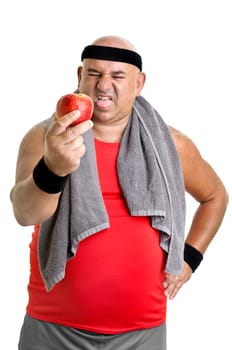 Large fitness man with an apple isolated in white