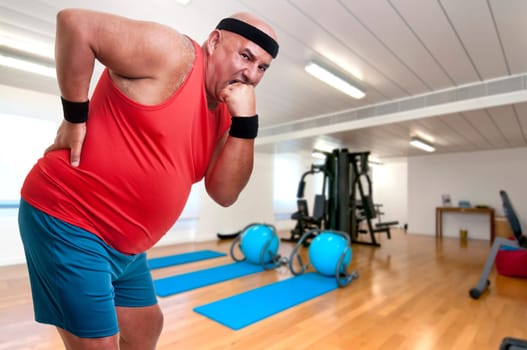 Large and tired fitness man with back pain