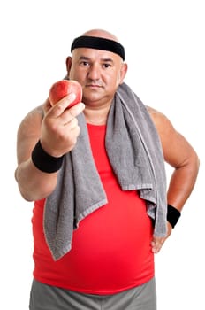 Large fitness man with an apple isolated in white