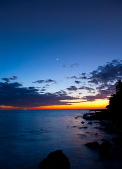 Moon crescent over a tropical island in the Gulf of Thailand
