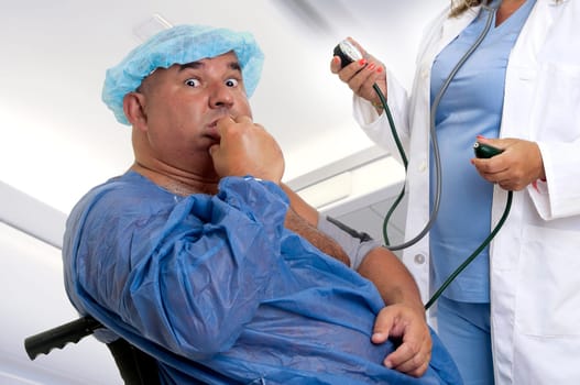 Large male patient in a wheelchair with doctor