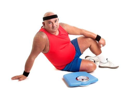 Large fitness man with weight scale isolated in white