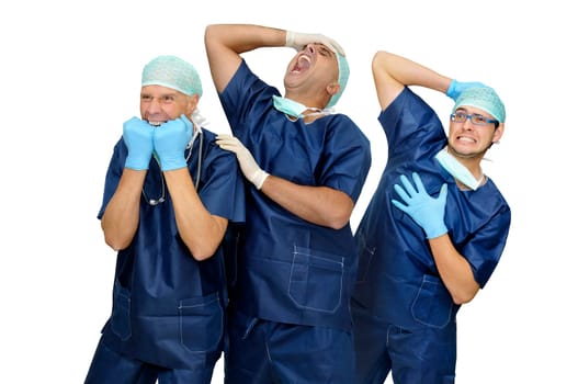 Doctors team in uniform making funny faces isolated in white
