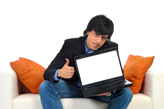 Young bussinessman in a couch with a laptop isolated in white