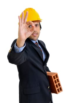Engineer with a brick isolated in white