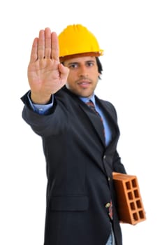 Engineer with a brick isolated in white