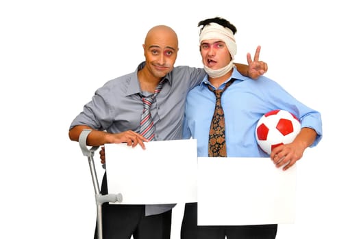 Two badly injured businessmen after a soccer match with empty cards , isolated in white