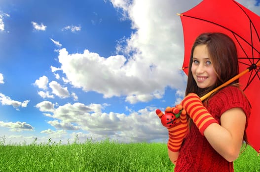 Beautiful girl with umbrella in a beautiful green grass