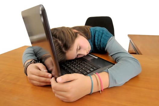 Young girlsleeping in front of a laptop computer