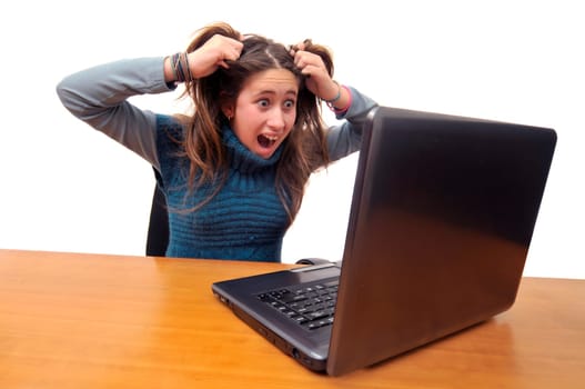 Stressed young girl in front of a laptop computer