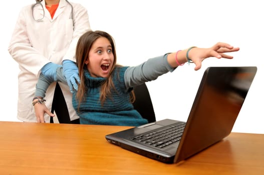 Stressed young girl being dragged by a doctor from her laptop computer