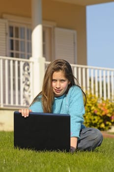 Girl on the grass with laptop