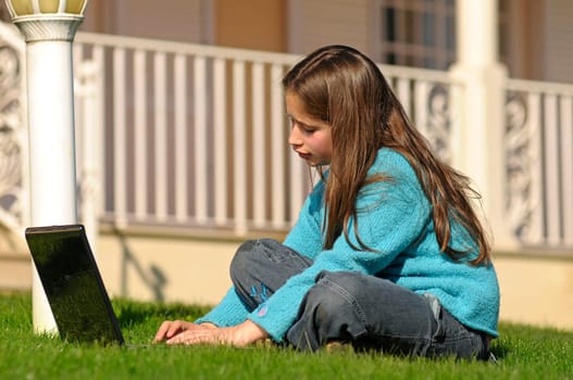 Girl on the grass with laptop